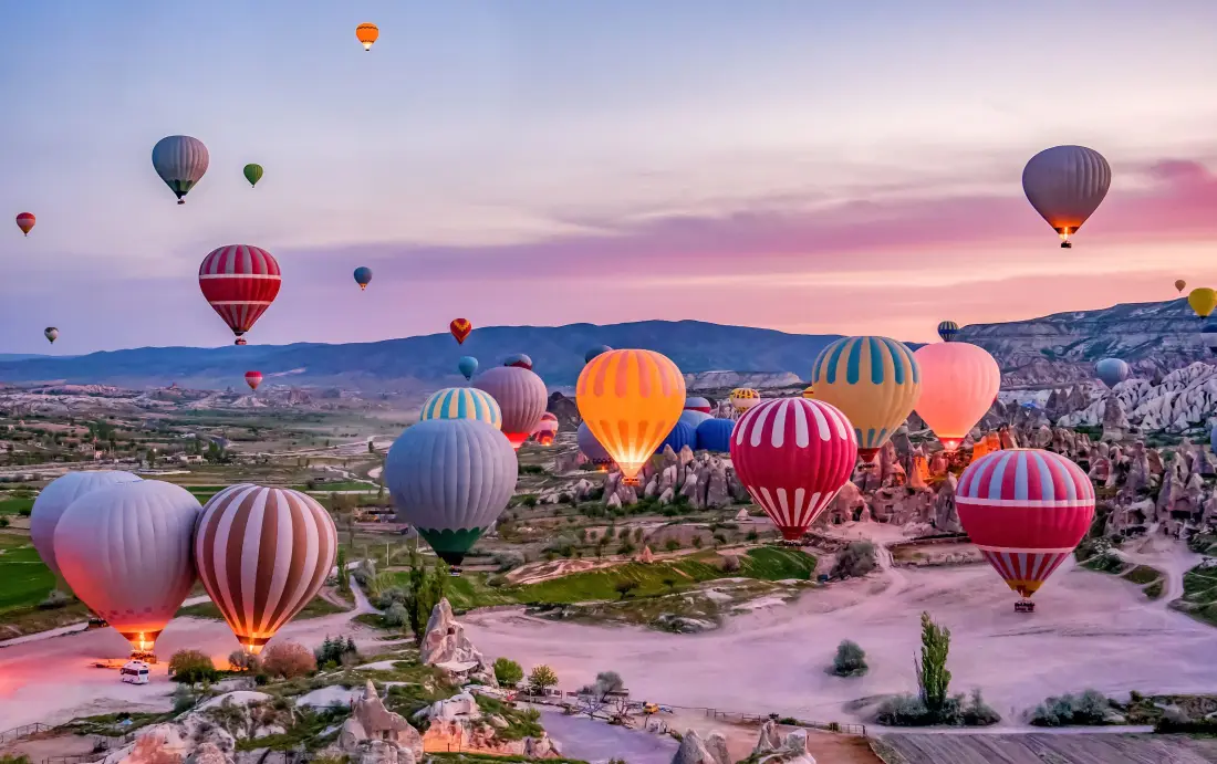 Bunte Heißluftballons starten über dem Göreme-Nationalpark in Kappadokien, Türkei